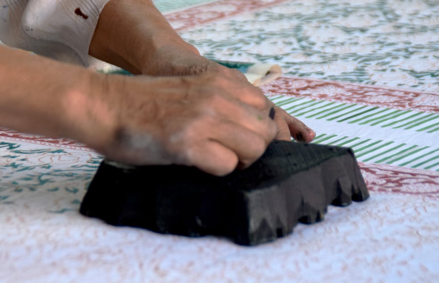 Hands holding a block print