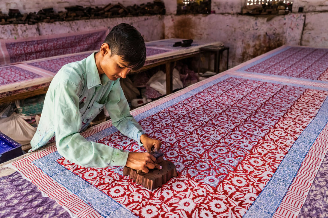 Young man working in a block printing factory in Jaipur, India